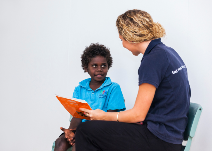 Image of teacher reading to a student implementing effective teaching strategies