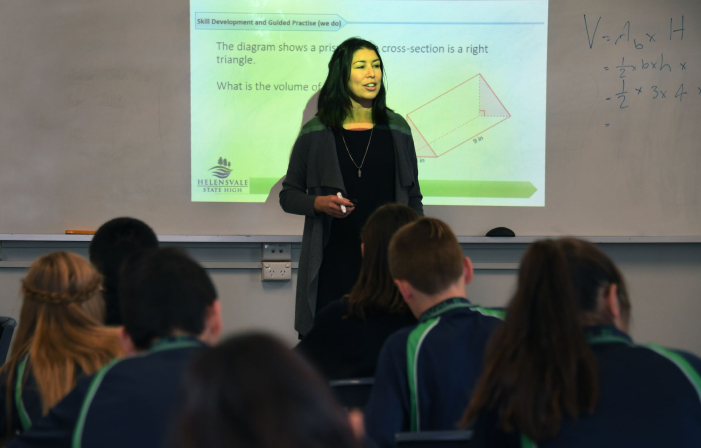 Teacher speaking to class as part of professional development program for teachers training