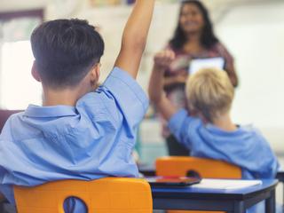 A teacher exemplifying one of the 10 essential classroom management skills as her class is focused and organised.