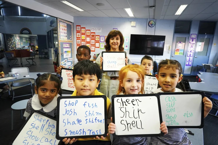 A teacher exemplifying one of the 10 essential classroom management skills as her class is focused and organised.