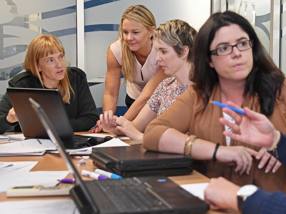 A group of professionals in a meeting room.